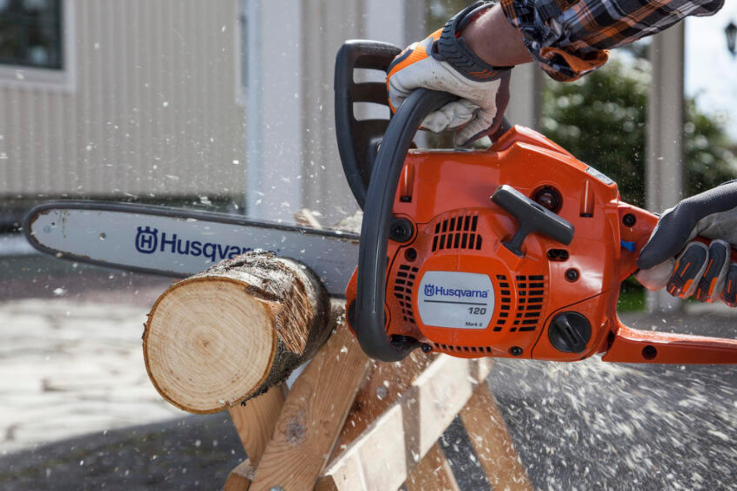 sawing through wood with chainsaw